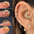 Gold and crystal ear cuff displayed on an ear with close-up views of the earring.